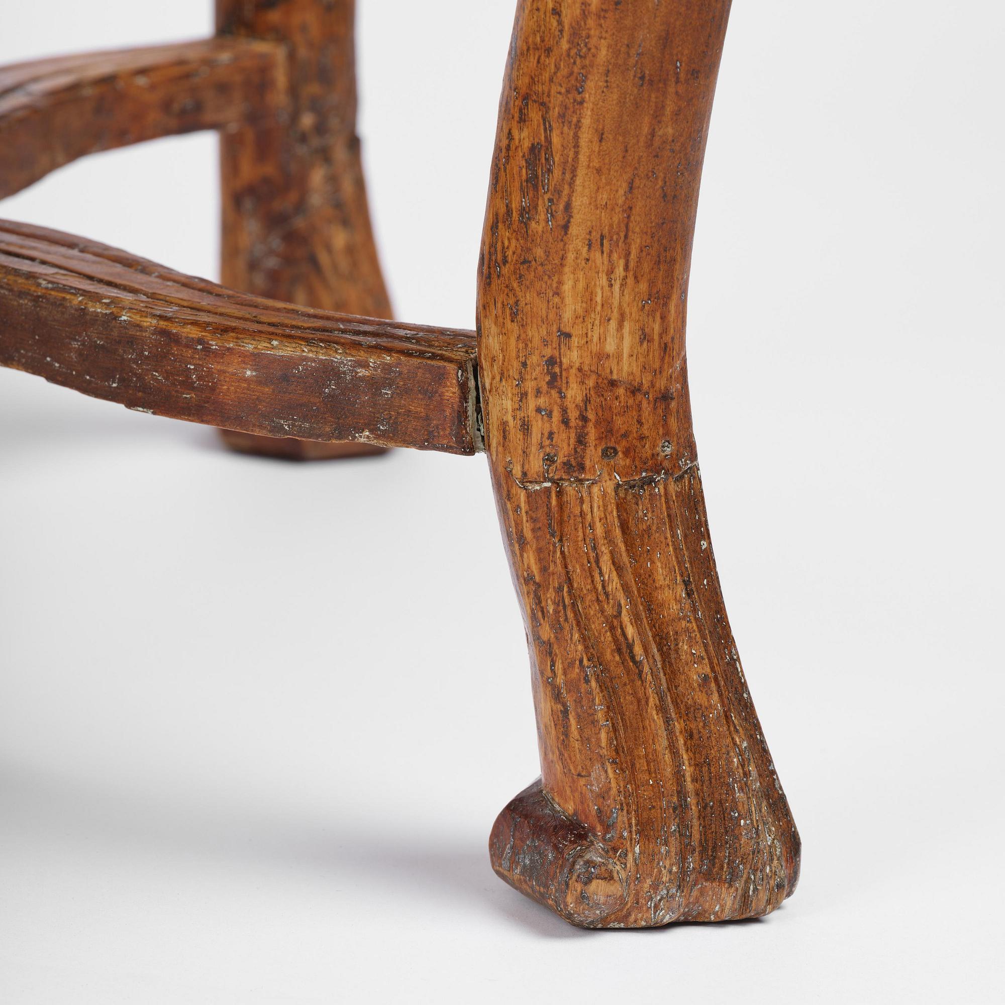 A pair of carved stools in the manner of Jonas Granberg, Jämtland, Sweden, mid 18th century.