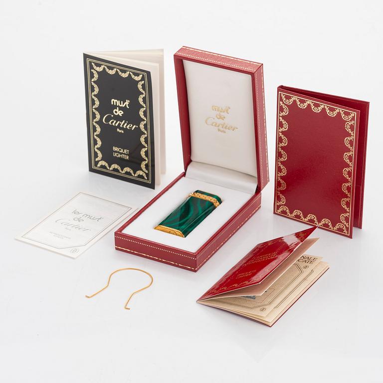 Cartier, A gilded and laquered metal lighter. Marked Cartier, Paris, 6846 X, Swiss made.