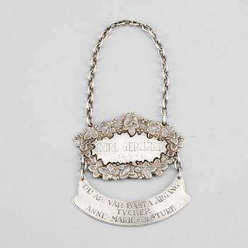 FLASKSKYLT, nysilver, 1900-tal.