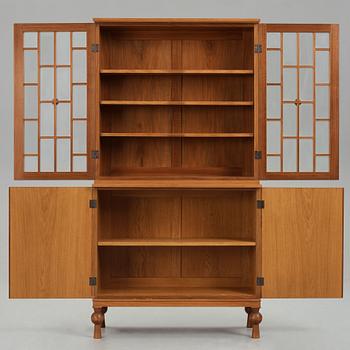 A Swedish Grace mahogany showcase cabinet, reportedly a win at the Stockholm Cabinetmaker's association lottery, 1920's.