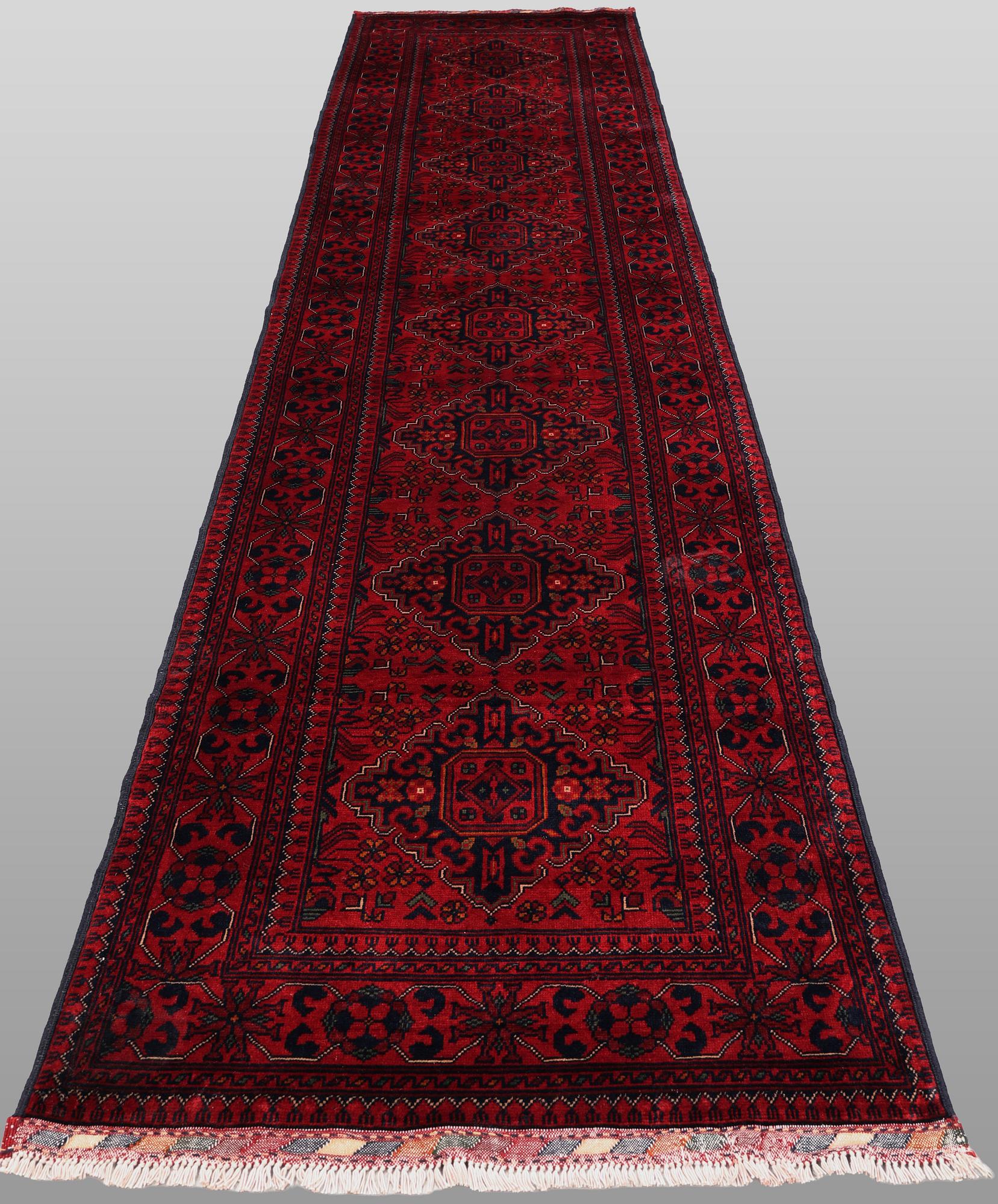 A Afghan runner carpet, 388 x 79 cm.