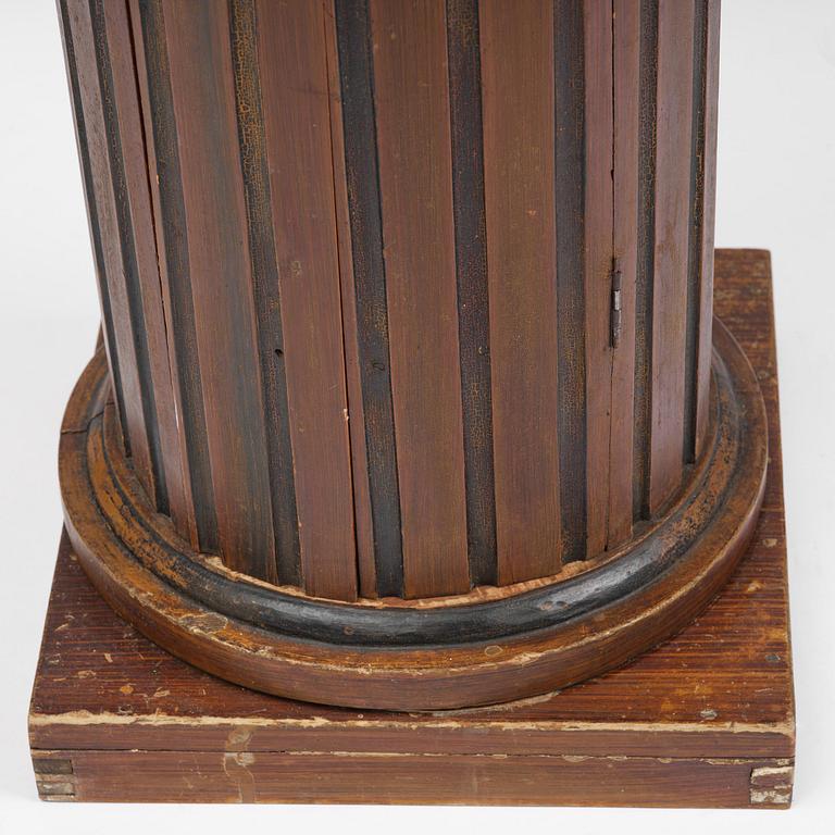 A Swedish Empire column-shaped cabinet, first part 19th century.