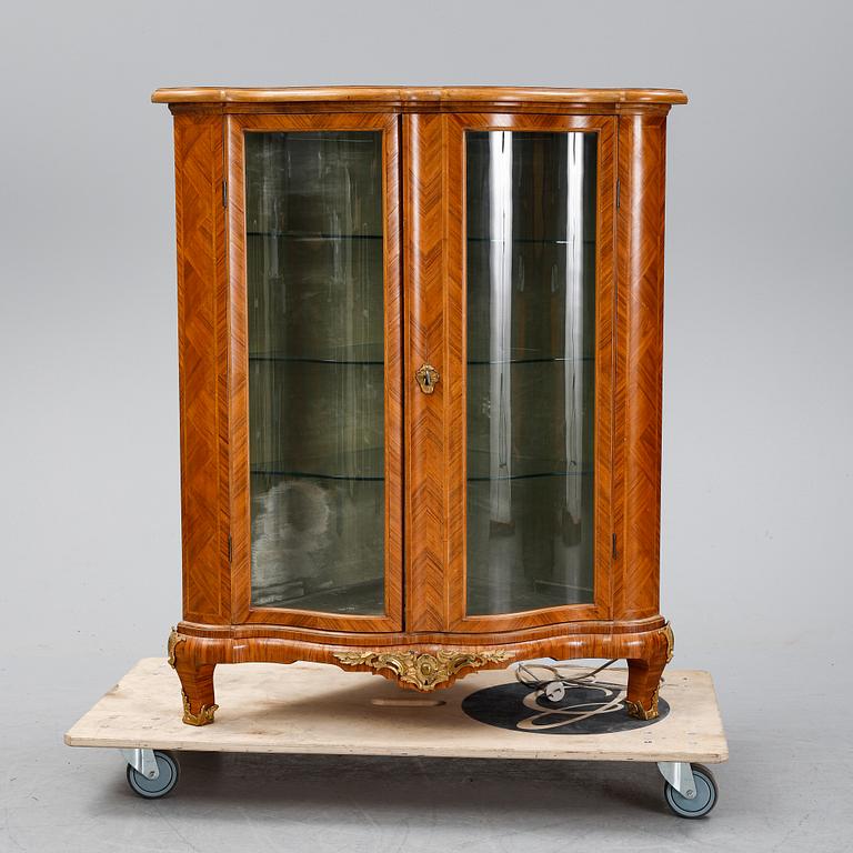 A 20th century Rococo style corner cabinet.