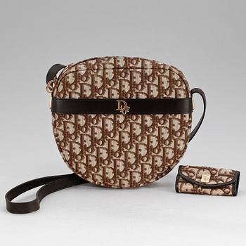 1428. A brown monogram canvas handbag and keyholder by Christian Dior.
