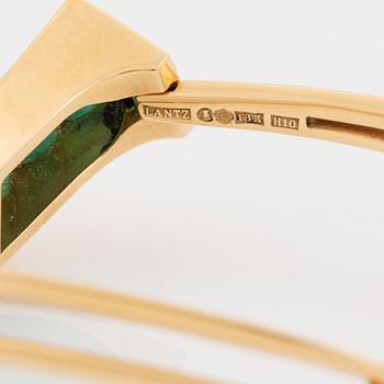 An 18K gold Lantz bracelet set with step-cut emeralds.