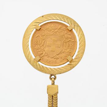 A keychain made of 18K gold with a 900 gold Helvetia 20 franc coin.