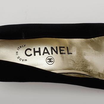 CHANEL, a pair of black satin pumps.