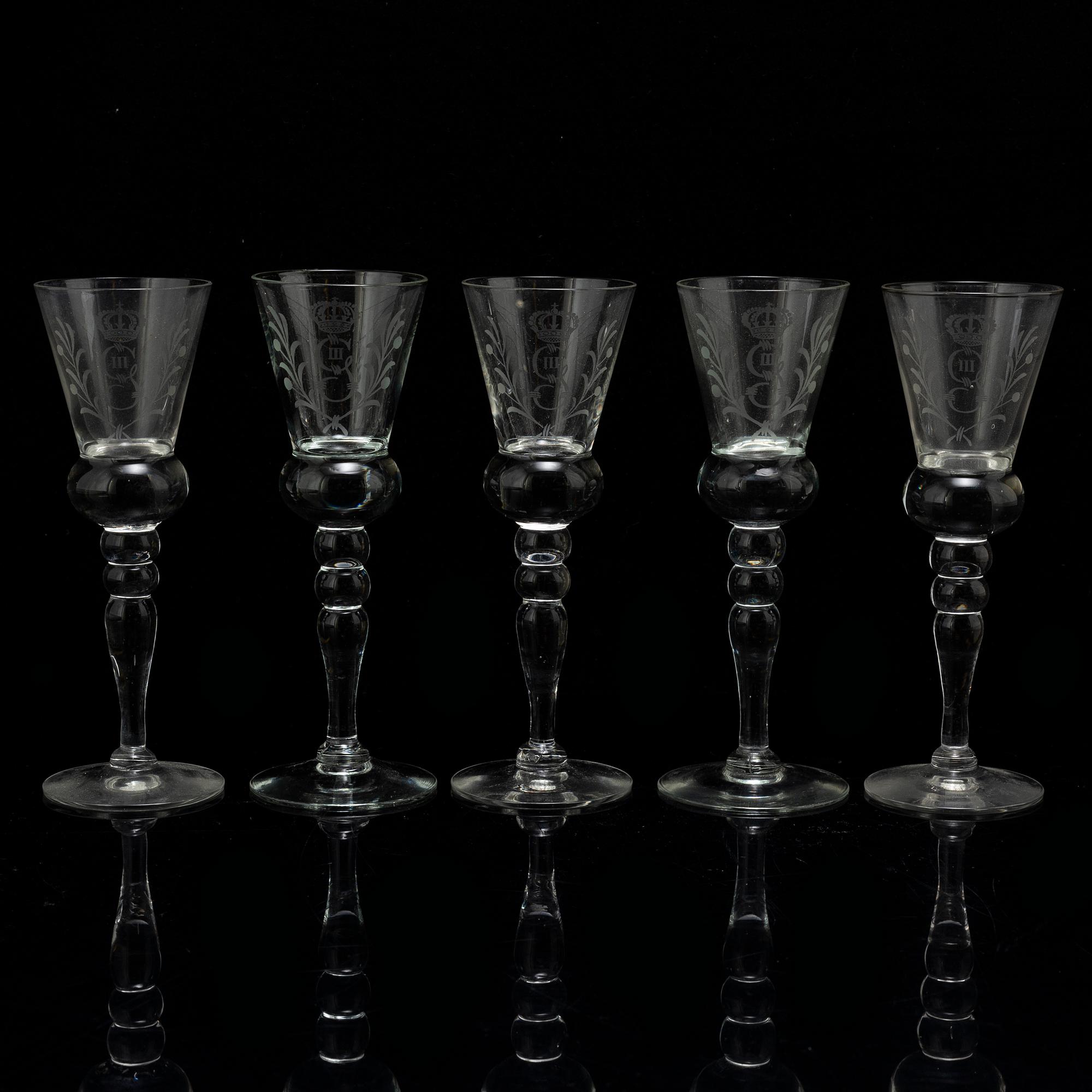 A set of five snapps glasses and a snapps bottle, with Gustav III crowned monogram. 20th century, Baroque-style.