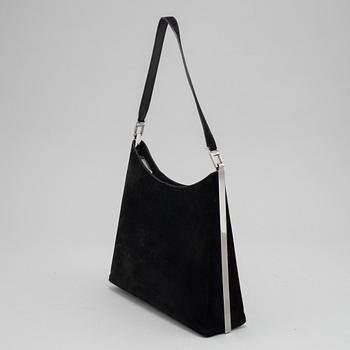 Salvatore Ferragamo, a black suede handbag.