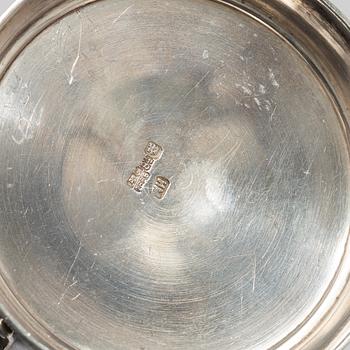 A Russian Silver Candlestick, 1908-26, and a Russian Silver Tea Glass Holder, assay master A. Skovronsky, Moscow 1896.