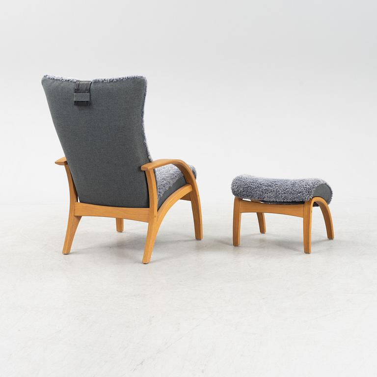 A 'Delta Adventure' wingback armchair and foot stool from Brunstad AS, Norway.