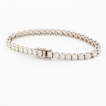 A tennis bracelet in 18K white gold set with round brilliant-cut diamonds total ca 11.50 ct, accompanied by GIA dossier.