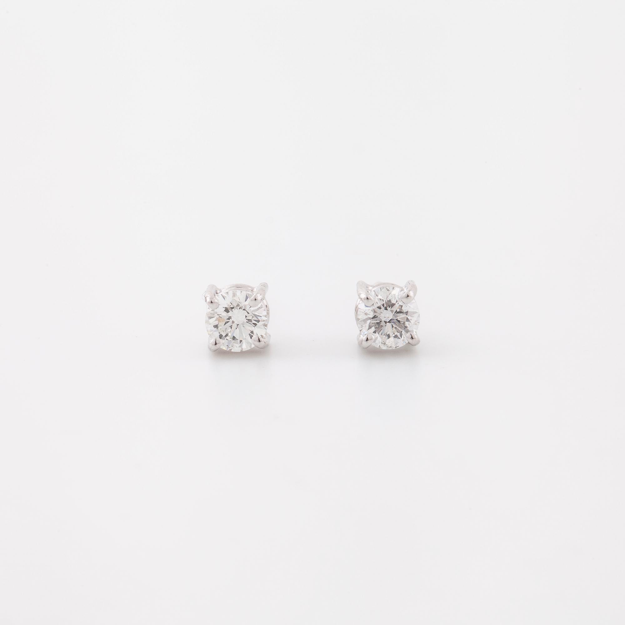 A pair of brilliant cut diamond earrings.