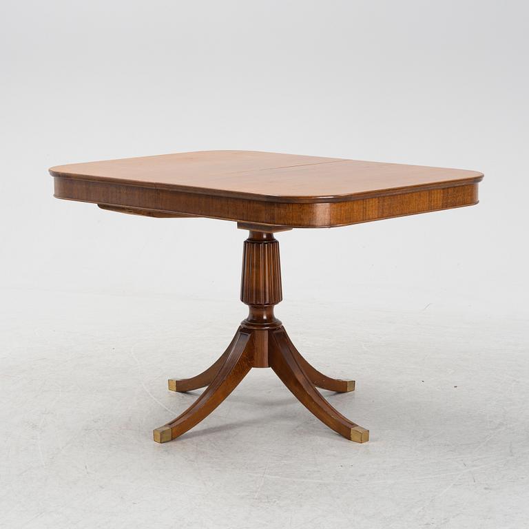 An mahogany veneered english style dining table, mid 20th century.