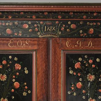 A Swedish polychrome painted folk art corner cabinet, dated 1818.