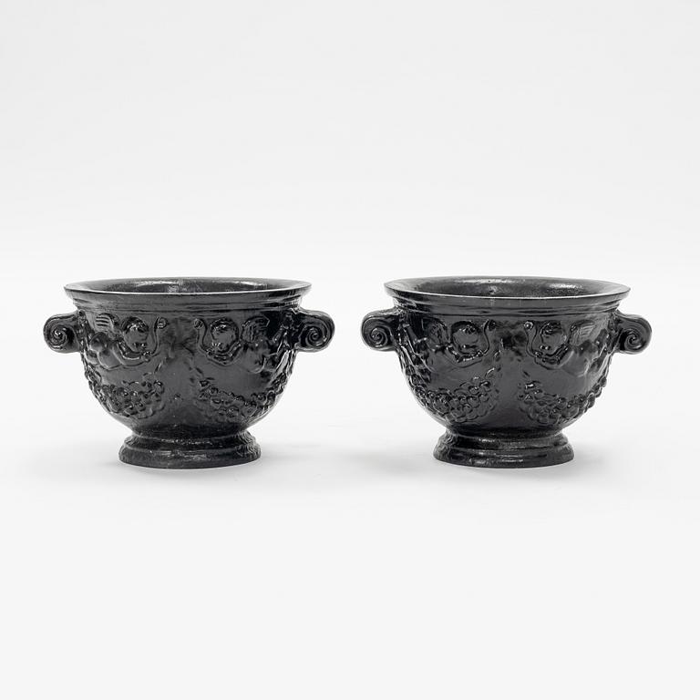 A pair of cast-iron urns.