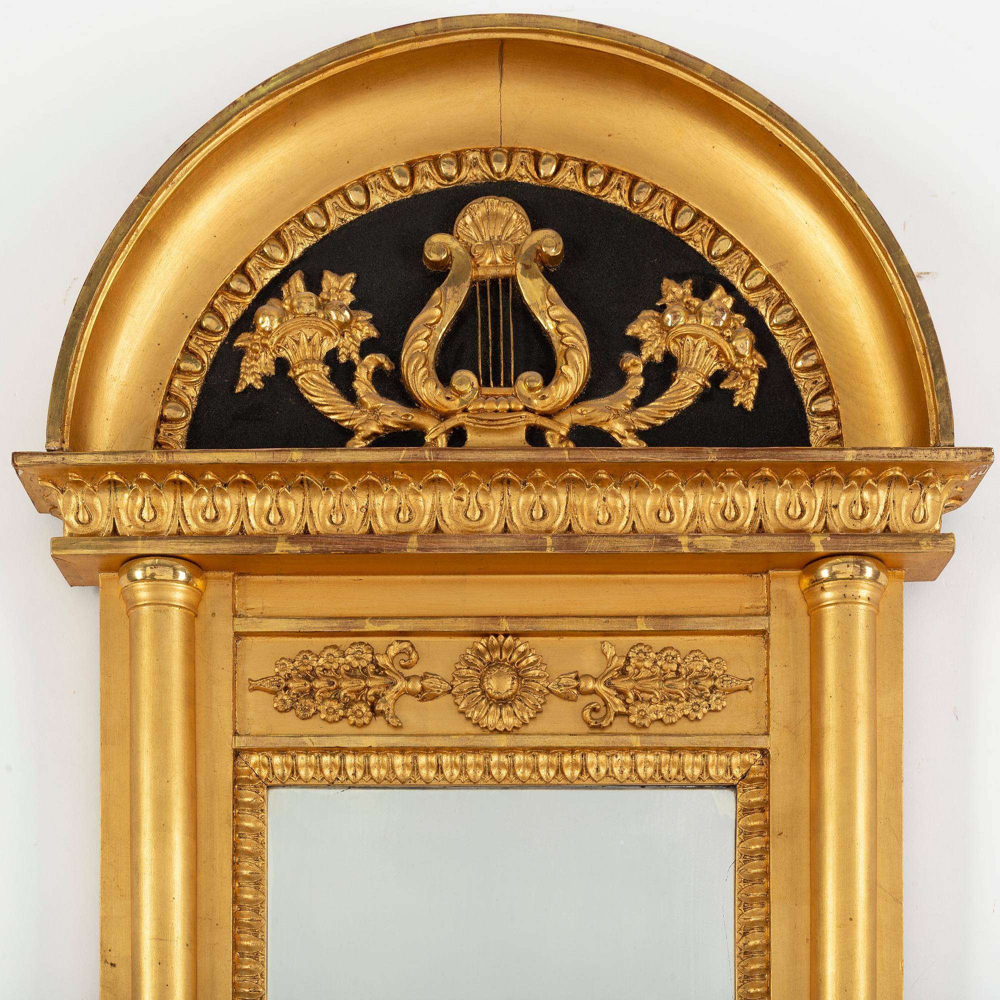 A 20th century Empire style gilt mirror.