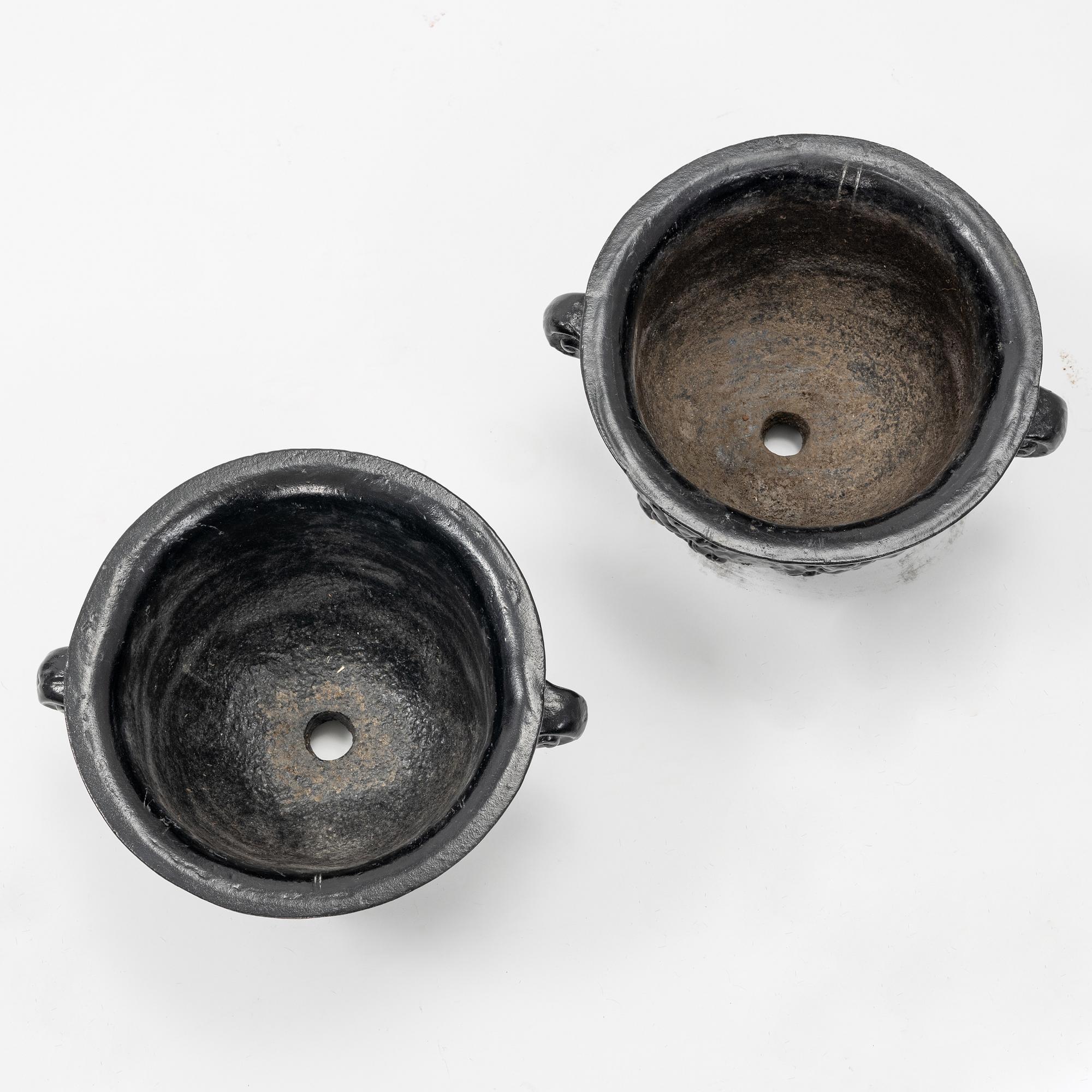 A pair of cast-iron urns.