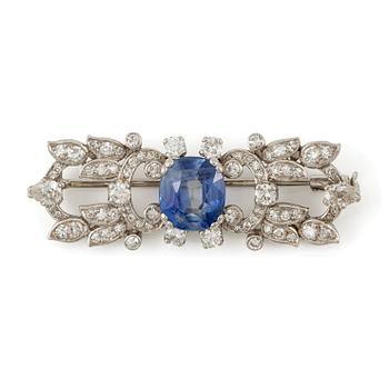 528. A W.A. Bolin brooch in platinum with a faceted sapphire.