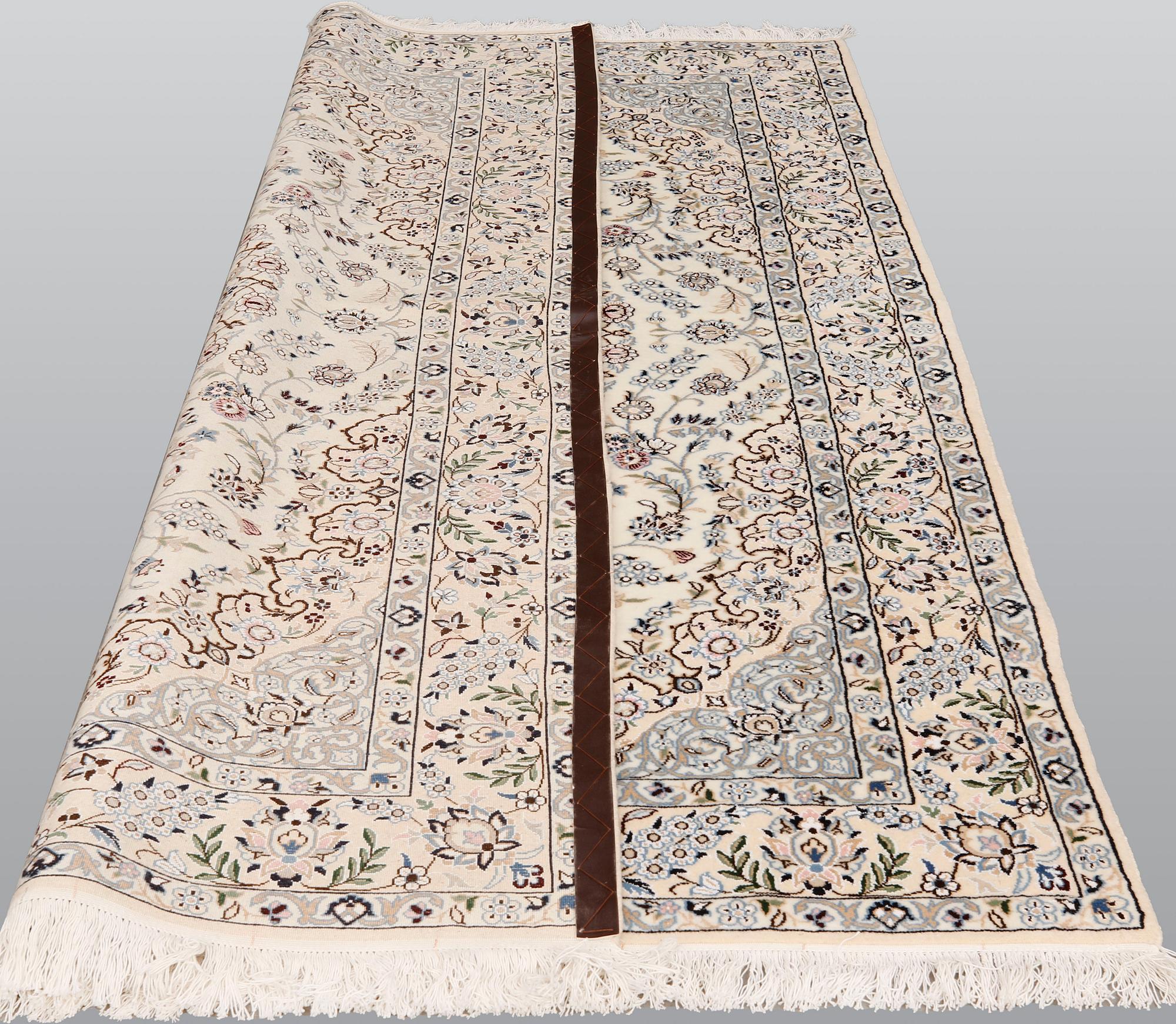 A Nain part silk carpet, 254 x 156 cm.