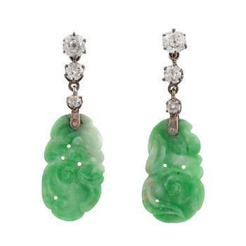 456. A pair of 18K white gold earrings with carved jadeite set with old-cut diamonds.
