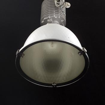 An industrial ceiling lamp marked Zumtobel Staff.