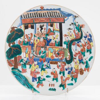 A famille rose dish decorated with a dragon festival moment, late Qing dynasty, China around 1900.