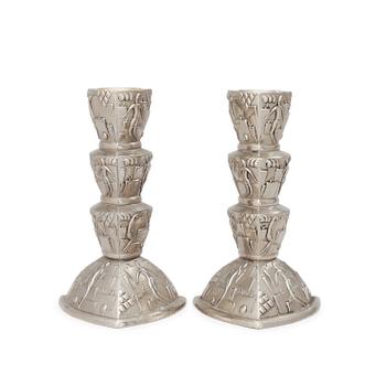 580. A pair of white metal candlesticks, 1920-30's.