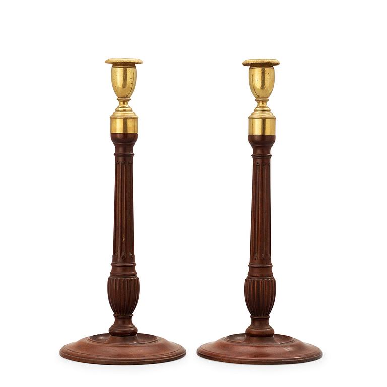 A pair of George III 18th century mahogany candlesticks.