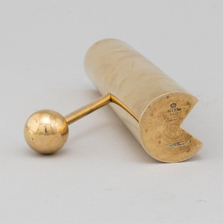 A brass candle holder by Pierre Forssell for Skultuna.