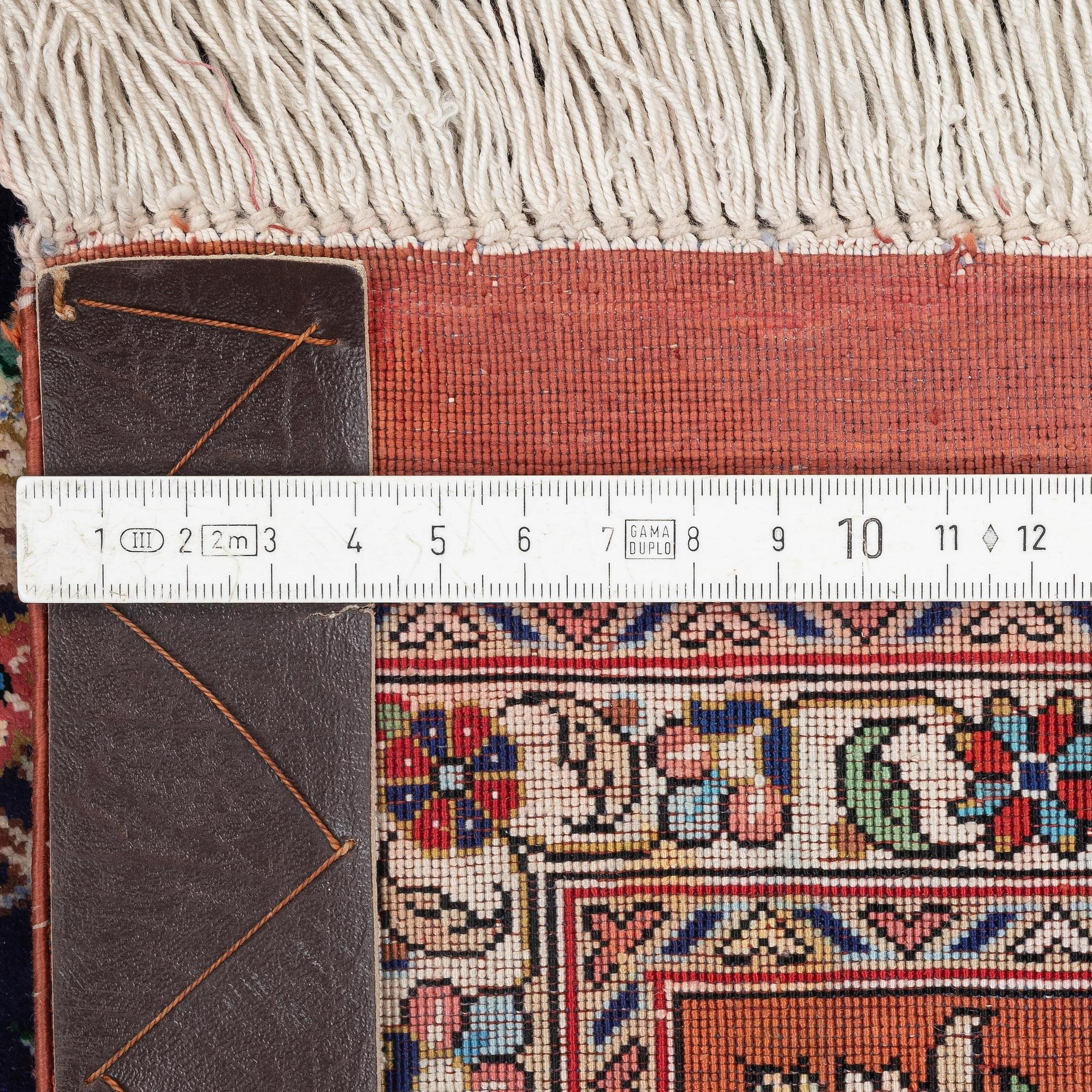 A signed pictoral silk Qum rug, c. 203 x 127 cm.