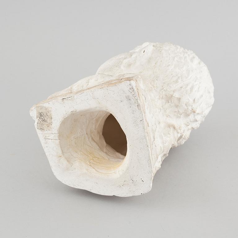 a plaster sculpture, signed.