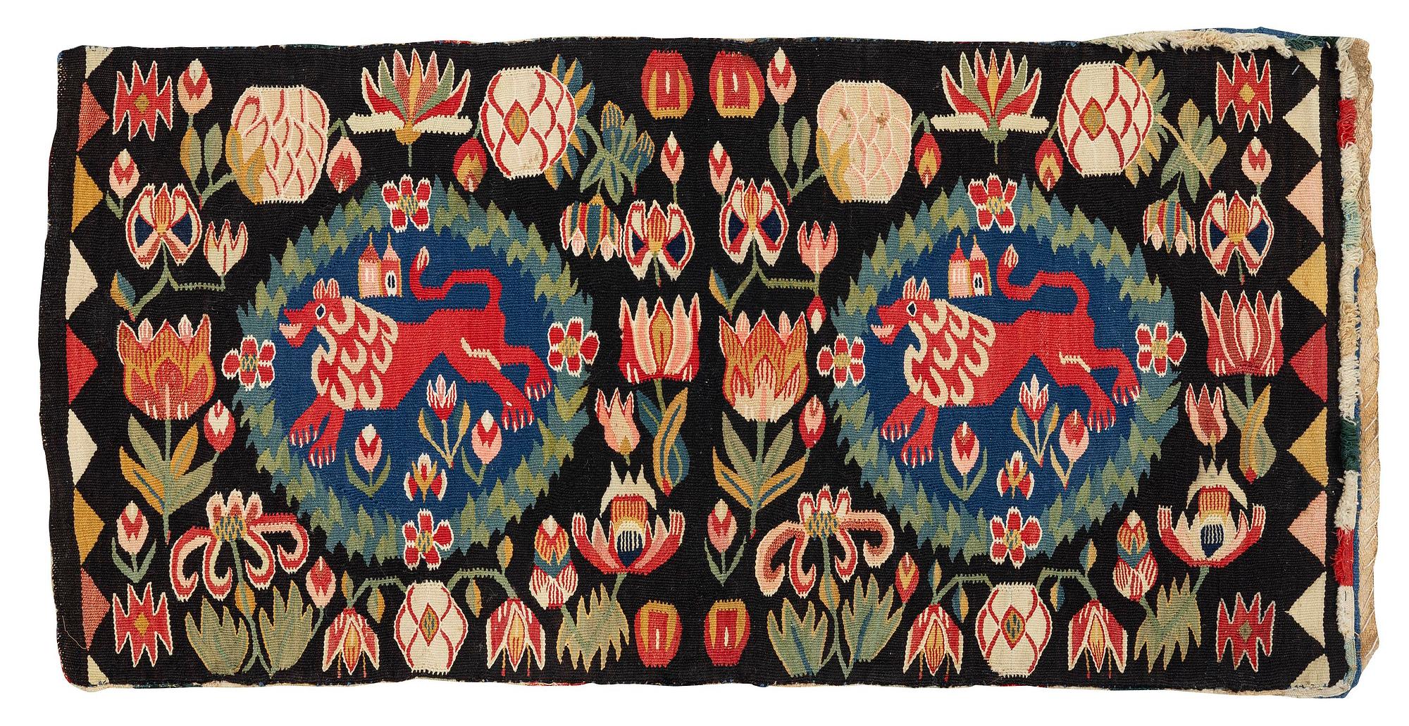 A cushion, 'Red Lion' (Rött Lejon), tapestry weave, c. 104 x 47 cm, Southwestern Scania, first part of the 19th century.