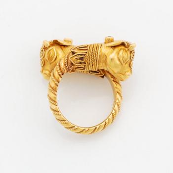 A 22K gold ring set with emeralds.