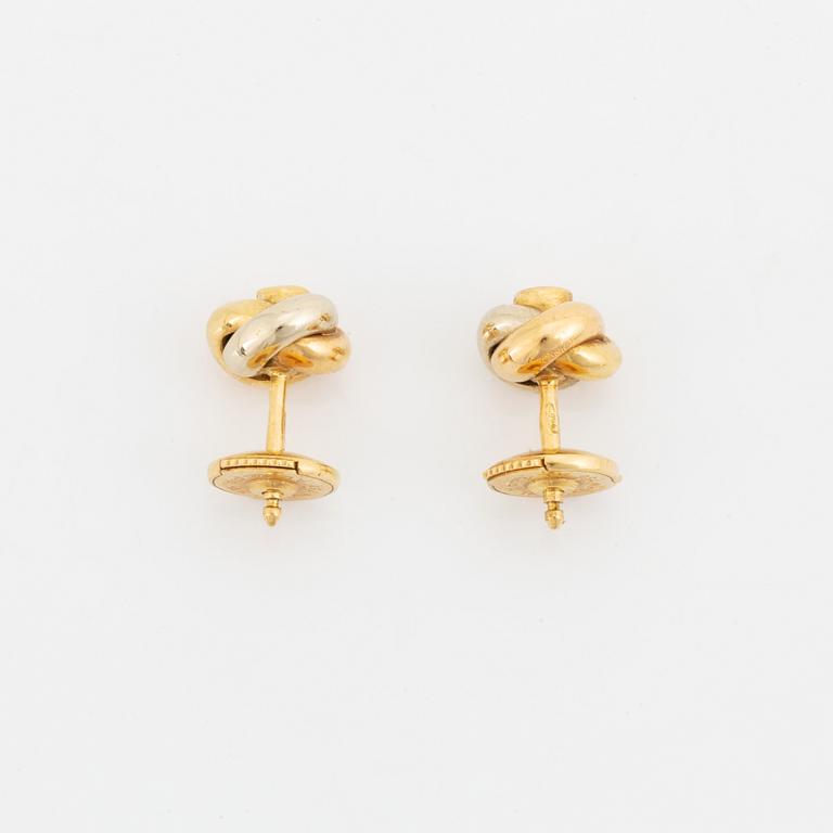 A pair of 18K gold Cartier "Trinity" earrings set with round brilliant-cut diamonds.