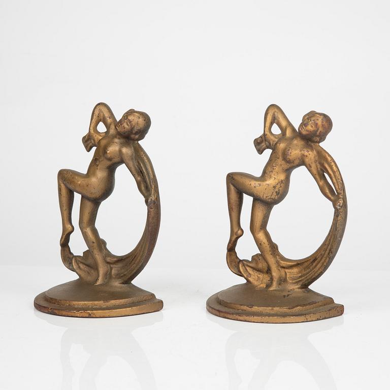 A pair of bronze patinated metal book stands, 1900´s.