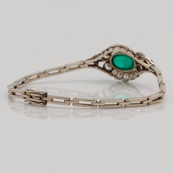 A cabochon cut emerald and brilliant cut diamond bracelet. Total carat weight of diamonds circa 1.10 cts.