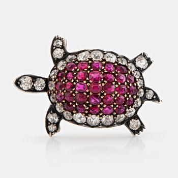 A silver and 14K gold brooch set with old-cut diamonds and rubies.