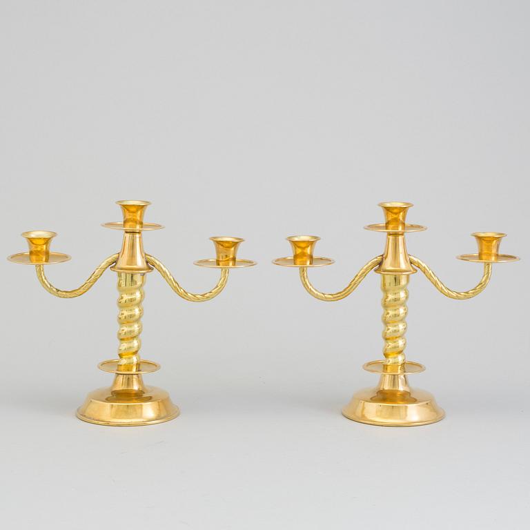 a pair of brass candelabras by Gottfrid Carlsson Eskilstuna.