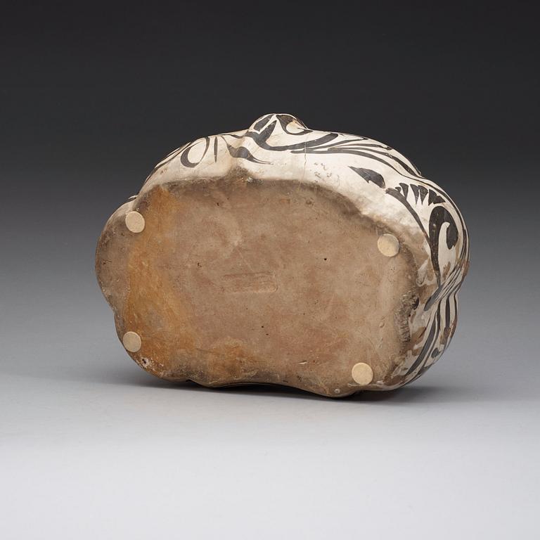 A white and black glazed pillow, Song dynasty (960-1279).
