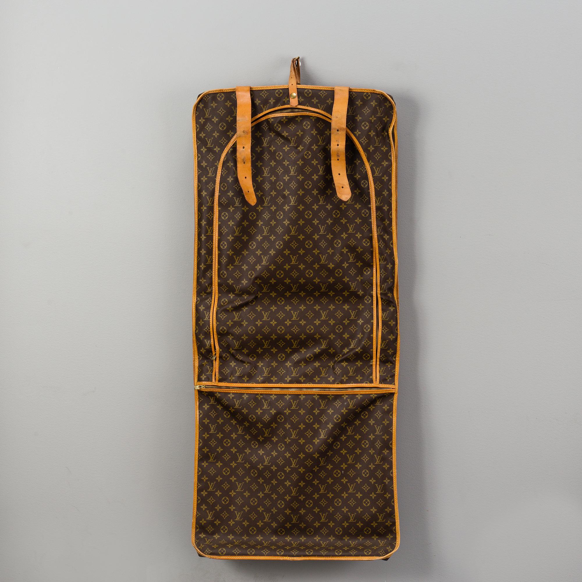 A Louis Vuitton vintage Monogram Canvas Homme Garment Bag.