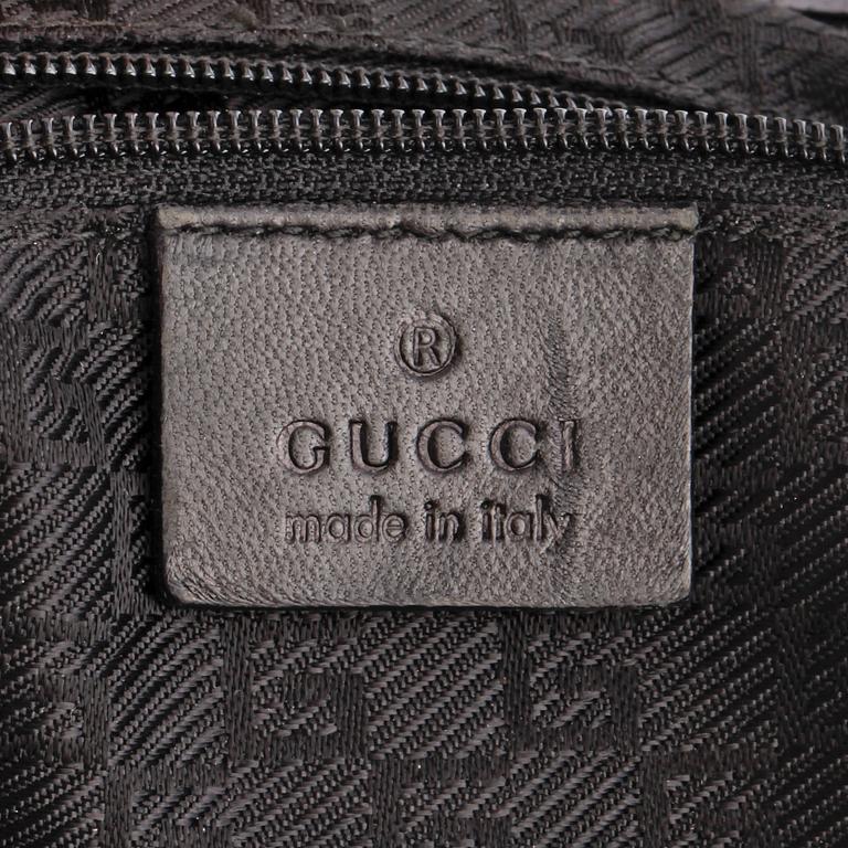 GUCCI, a black fur and crocodile shoulder bag.