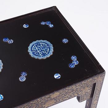 A Chinese black lacquered table with porcelain placques, presumably first half of the 20th century.