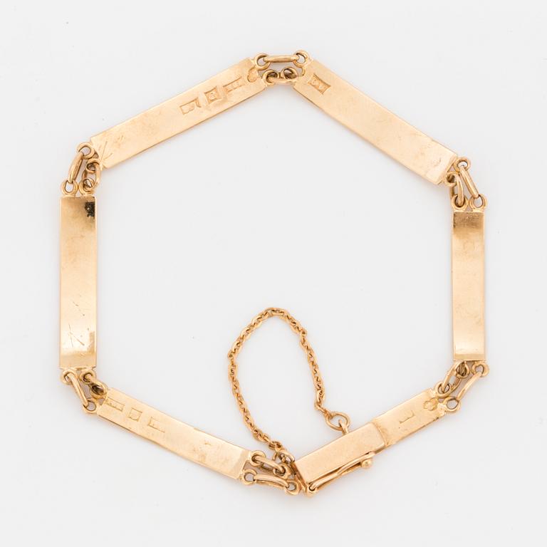An 18K gold bracelet.