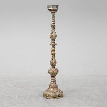 A wooden altar candlestick.