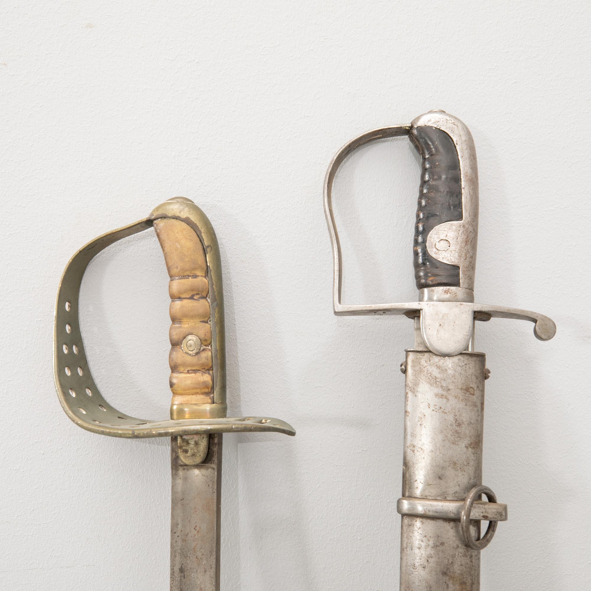 Swords 2 pcs, Swedish, m/1867 for the cavalry, and m/1831 for artillery personnel, with scabbard.