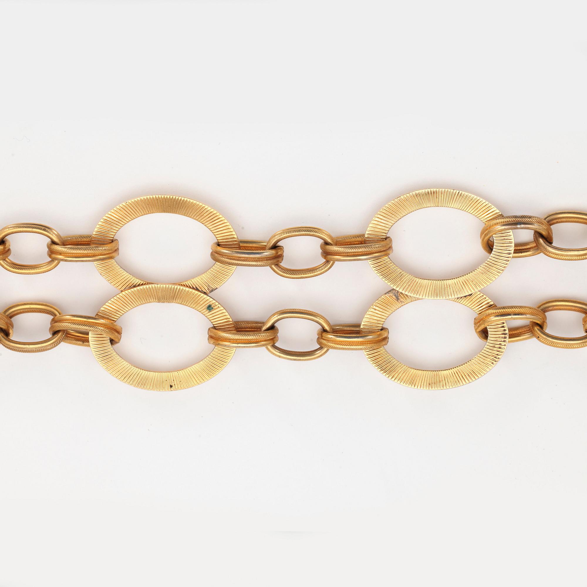 YVES SAINT LAURENT, a gold colored metal chain.
