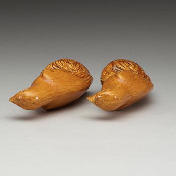 A pair of brown and yellow glazed figures of parrots, Qing dynasty, presumably 18th Century.