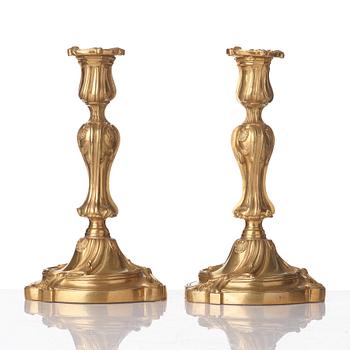 A pair of French Louis XV mid 18th century gilt bronze candlesticks.