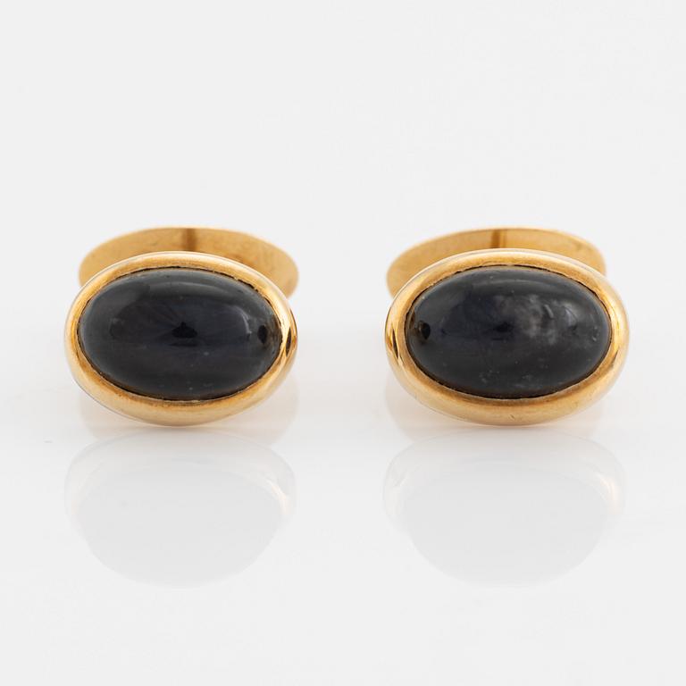 18K gold and cabochon cut blue stone cufflinks.
